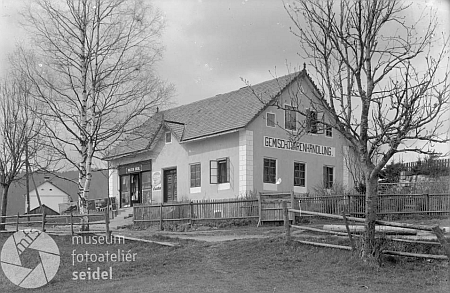 Jeho obchod se smíšeným zbožím na dvou snímcích z roku 1926