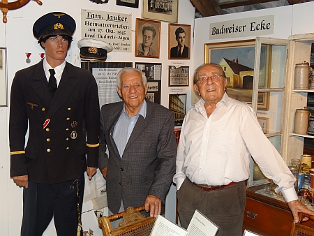 V rodinném muzeu stojí tu vpravo Edmund Wiltschko, vlevo Josef Jauker pod snímkem své ženy Christl, roz. Pflegerové, kterou si vzal v březnu 1951 - vpravo na zdi pod nápisem "Budweiser Ecke" lze zahlédnout obraz s původní podobou domu čp. 5 ve Vrátě (viz níže)