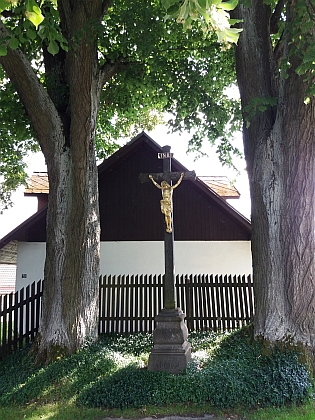 Kříž mezi starými lípami před domem čp. 23